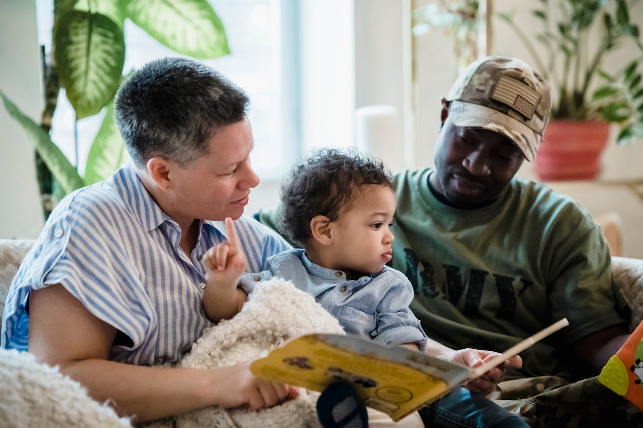 Diverse family enjoying a cozy reading session on the couch together.